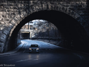 Car under dark bridge